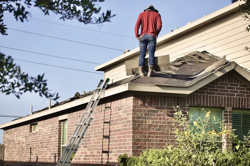 Professional roofer working on a residential roof in Crescentville